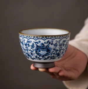 Hand-painted blue and white porcelain teacup with interlocking lotus pattern front view