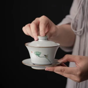 Full set of vintage hand-painted lotus crackle glaze gaiwan on wooden background