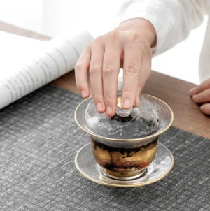 Full view of hammered transparent glass gaiwan with gold trim 3-piece set