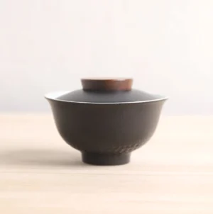 Full view of handcrafted 5oz black ceramic Japanese gaiwan with wood accents