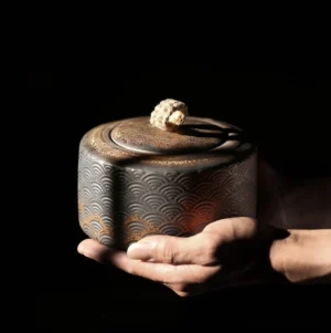 full view of vintage bronze ceramic tea container with wave carving