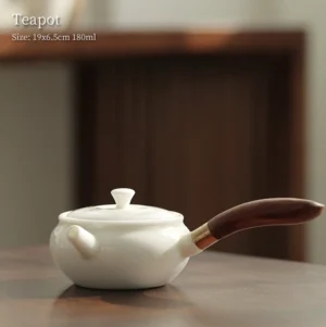 Full side view of handcrafted 6oz white porcelain side handle teapot with dark wood grip and brass connector